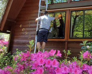 asf clean team service technician cleaning a residential window