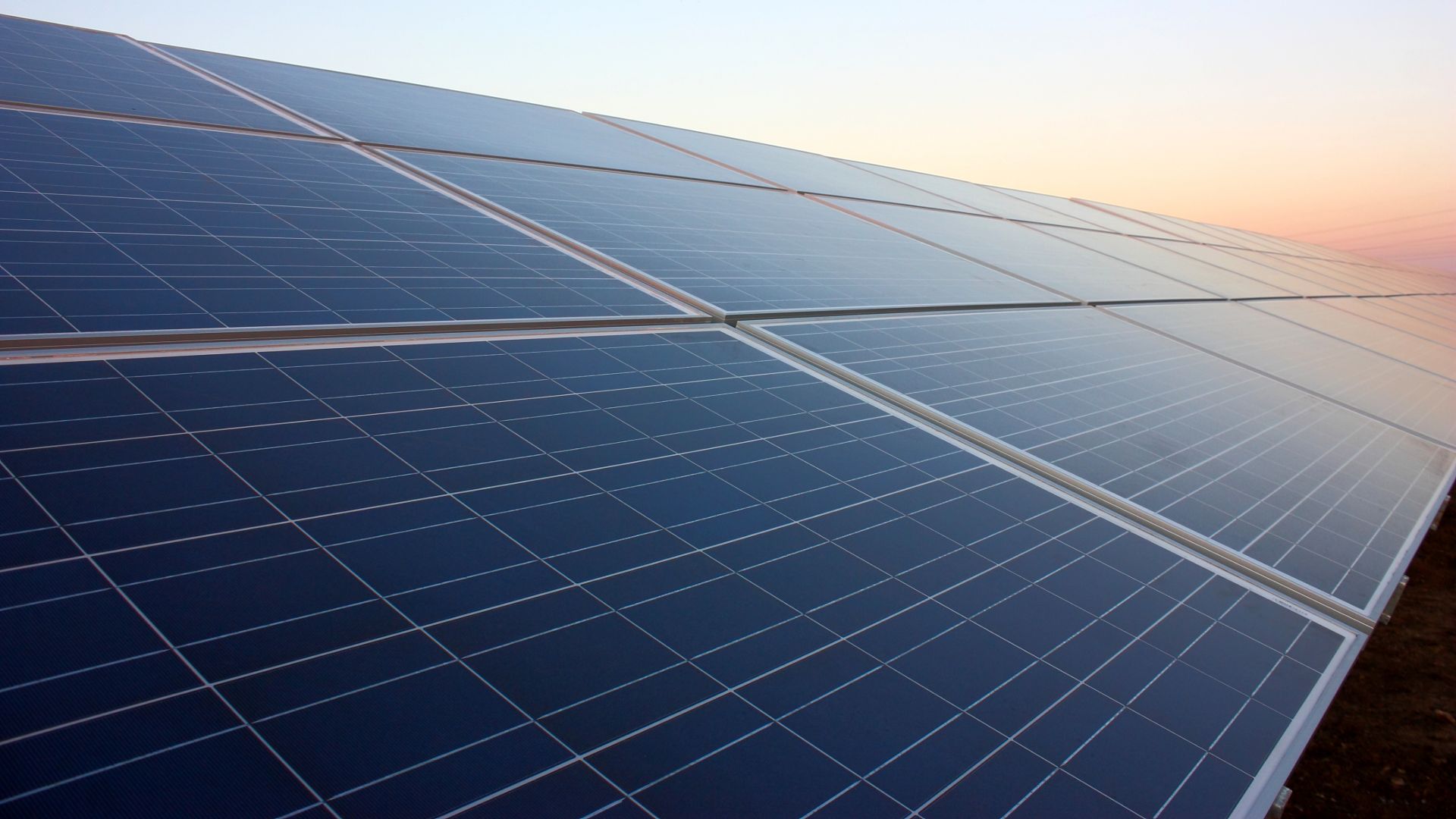 a set of clean solar panels boost energy in the sunset