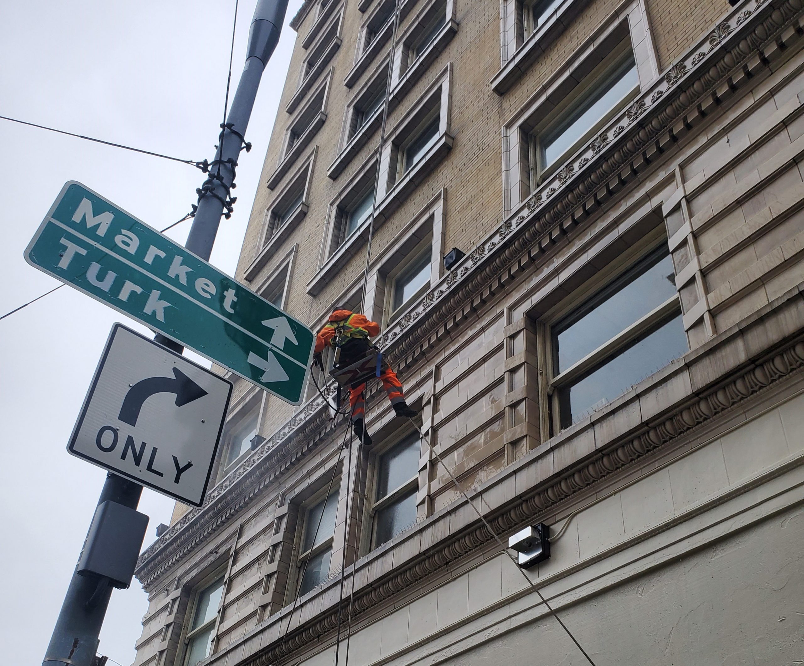 man washing high rise windows in San Francisco