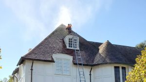 a professional man soft washing a roof in San Francisco
