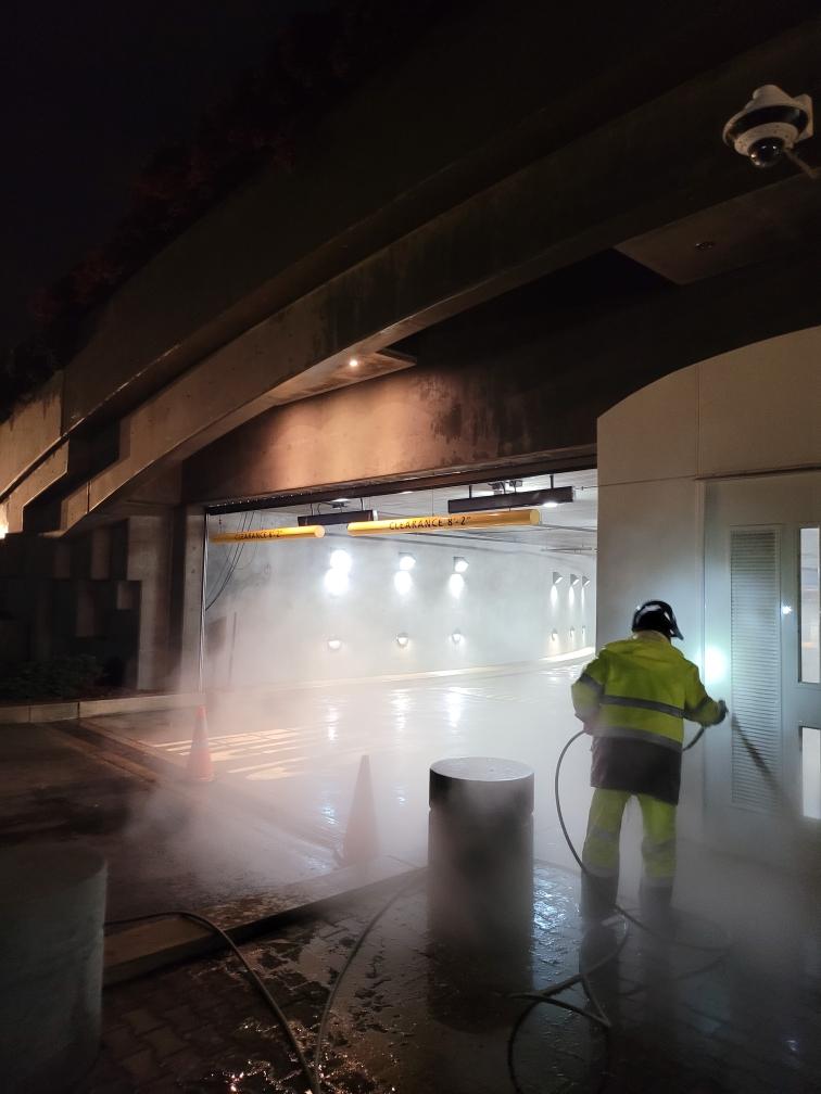 commercial exterior cleaning contractor uses pressure washing to clean car parking lot