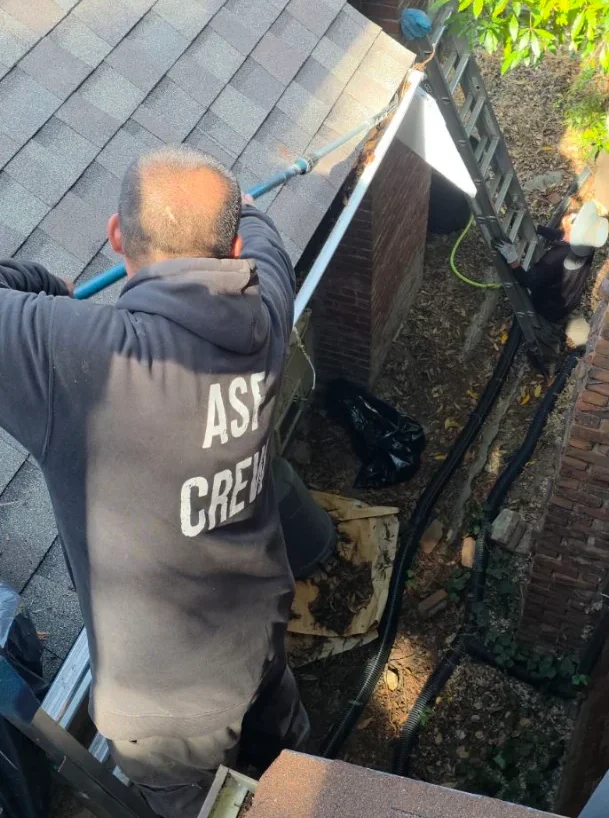 ASF Clean Team cleaning a downspout and gutter in Oakland